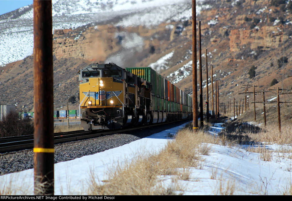UP 8664, 9021, 7781 (SD70ACE, SD70ACE, C45ACCTE) lead an eastbound stack train through Echo Canyon Utah, February 19, 2022 {Winter Echofest}